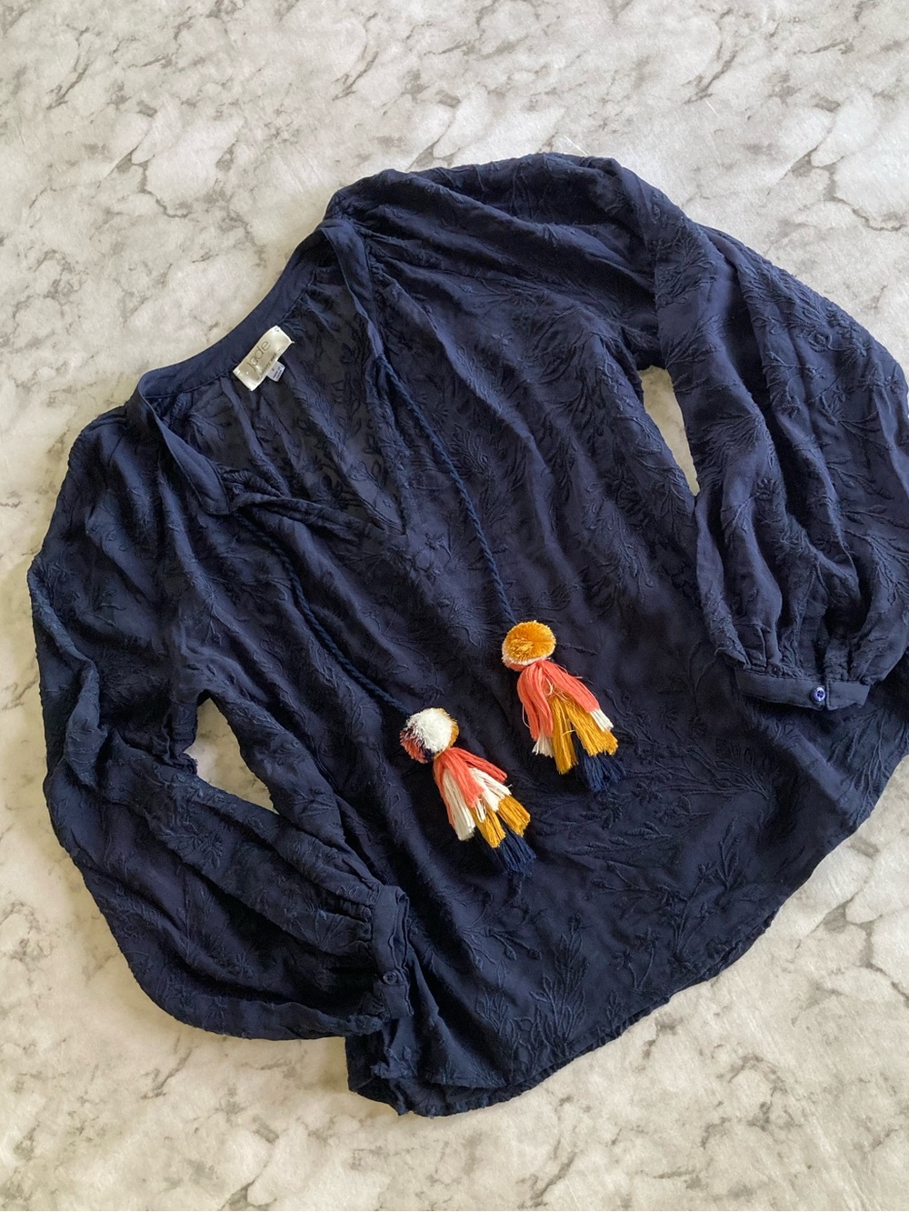 Navy embroidered peasant long sleeve top with tassel accents